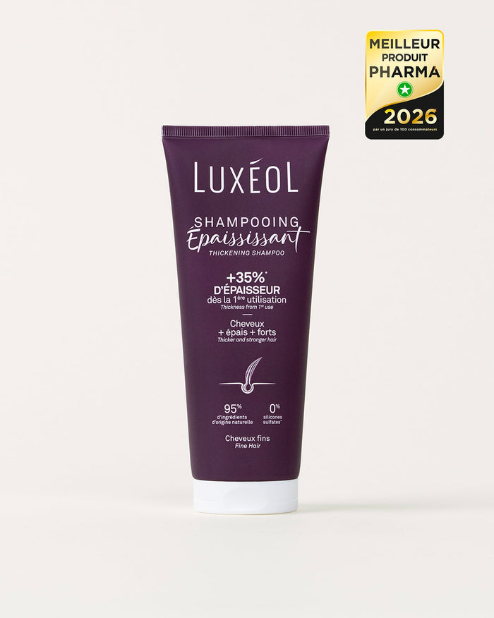Violetinio šampūno vamzdelis, pažymėtas „Luxéol“, baltame fone su auksiniu apdovanojimo ženkleliu.